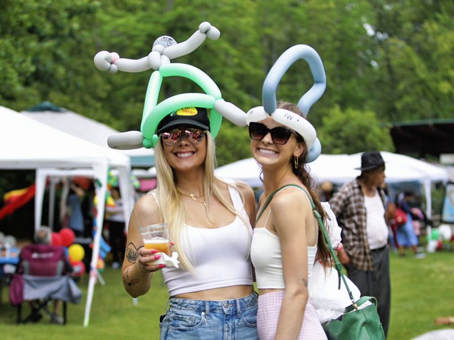 Friends in balloon hats enjoying the festival