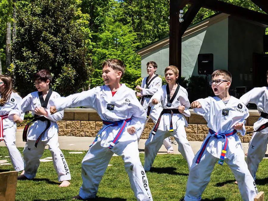 Kids in martial arts uniforms performing in the Kid Zone